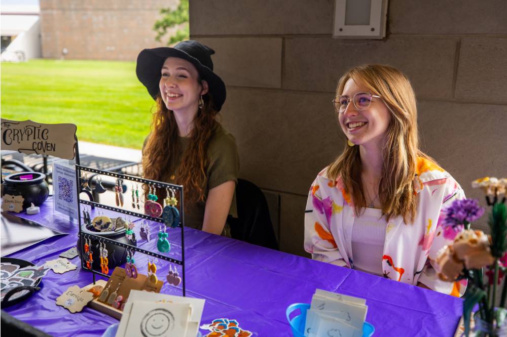 Students working a booth during Student Small Business Market.